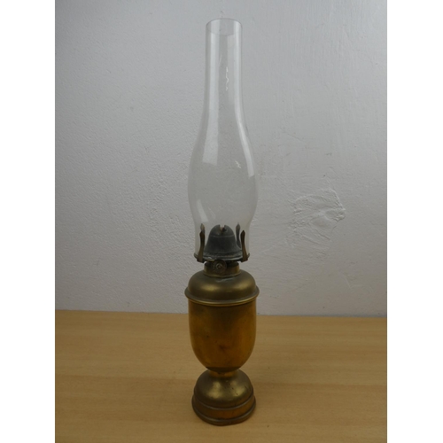 679 - An antique oil lamp with heavy brass base.