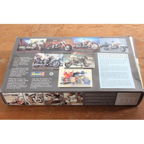 101 - A Revell Harley Davidson - Electra Glide model kit and book.