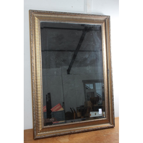 75 - A gilt framed rectangular wall mirror.