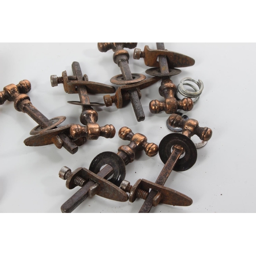 74 - A lot of antique brass stair rod clips & handles.