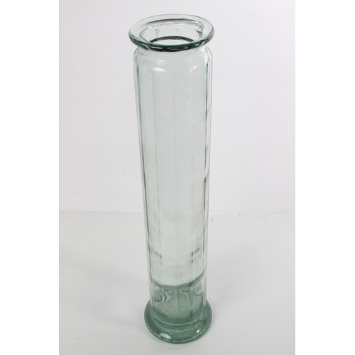 129 - A tall glass container.