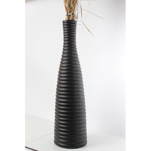 153 - A tall ceramic vase and contents.