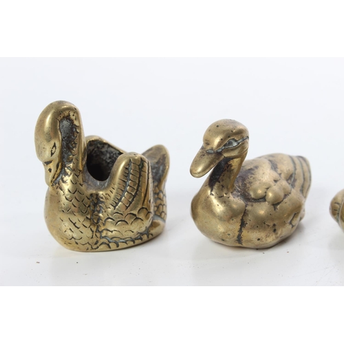 189 - A set of four vintage brass ornamental ducks and another swann.