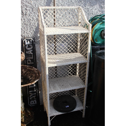 62 - A wicker/ cane shelving unit.