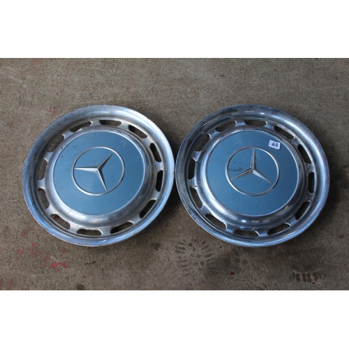 68 - Two vintage Mercedes hubcaps.