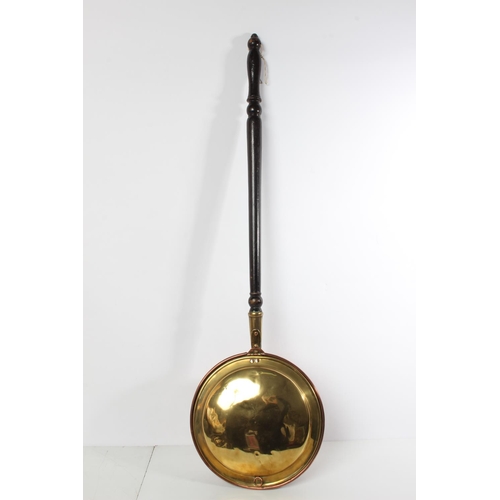 69 - An antique brass and copper bed warmer.