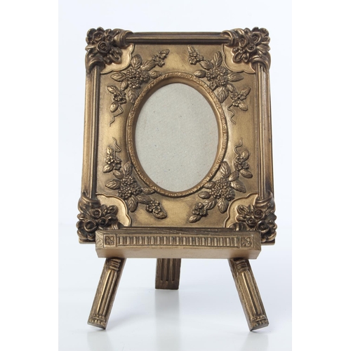 112 - A decorative picture frame and easel stand.