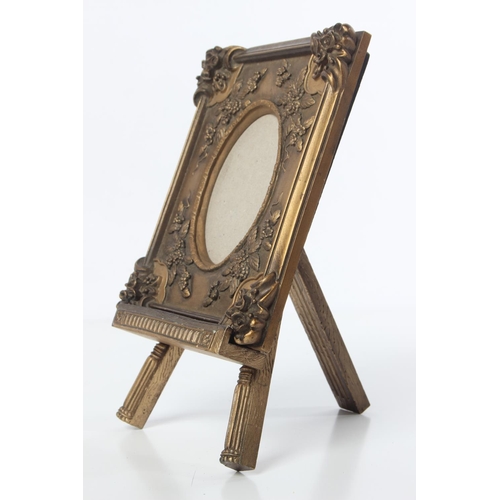 112 - A decorative picture frame and easel stand.