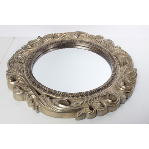 122 - A wood framed circular mirror.