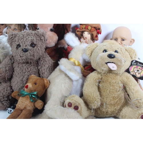 125 - A large lot of vintage dolls and soft toys.