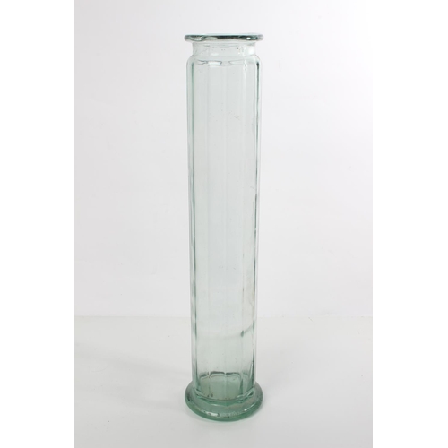 129 - A tall glass container.