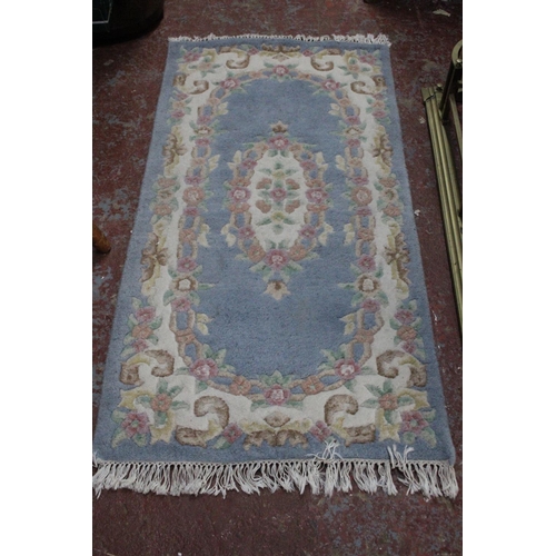 176 - A floral blue floral patterned floor rug.