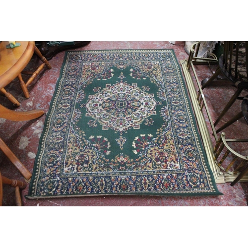 178 - A green patterned floor rug.