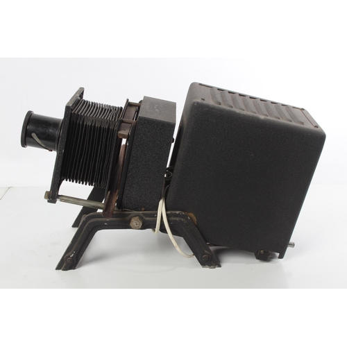 185 - A vintage Newton & Co Ltd magic lantern projector with wooden slide carrier and slides.