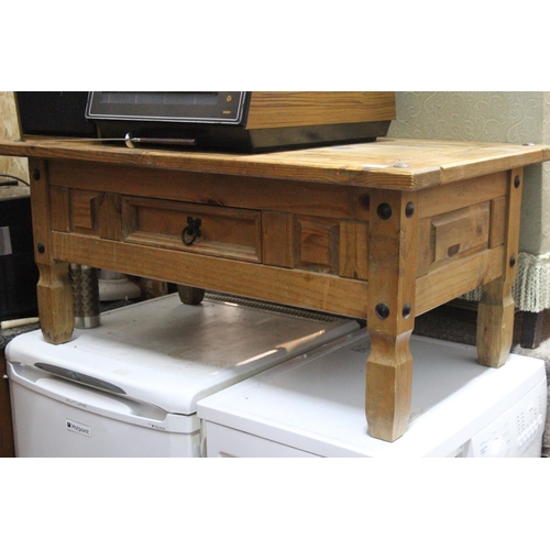 235 - A chunky pine coffee table with wrought iron detail and drawer.