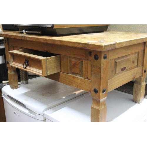 235 - A chunky pine coffee table with wrought iron detail and drawer.