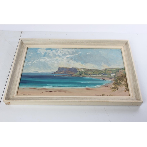 356 - An oil painting on board of the North Antrim Coastline signed Mabel G Young.