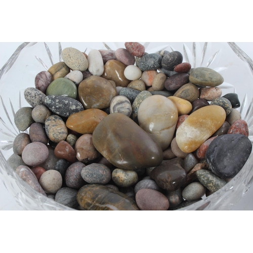 377 - Two glass bowls with a collection of precious stones.