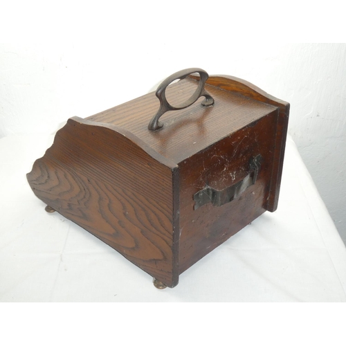 411 - An antique oak coal scuttle.