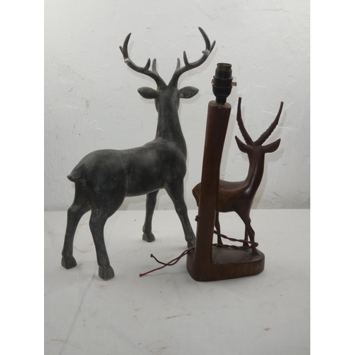 438 - A vintage wooden table lamp base of an Antelope and another figure.