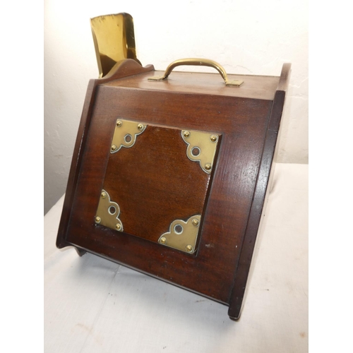 442 - An antique mahogany coal box with brass detail and shovel.