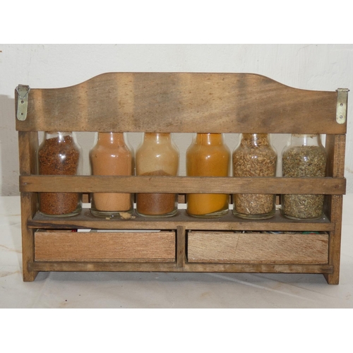 458 - A wooden spice rack and contents.