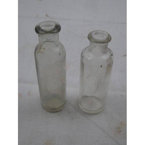 472 - Two vintage glass medicine bottles.