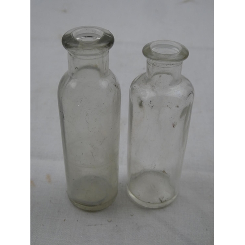 472 - Two vintage glass medicine bottles.