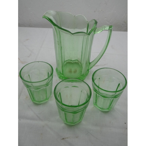 475 - A vintage green glass drinks set.