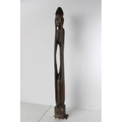 567 - A tall wooden African style figure.