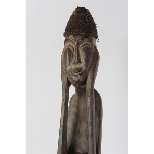 567 - A tall wooden African style figure.