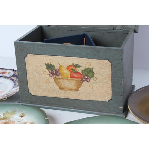 445 - A wooden box decorated with fruits and a collection of plates.