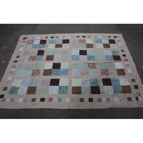 495 - A large vintage patchwork quilt, top and cover worked in a pattern of squares.