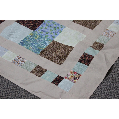 495 - A large vintage patchwork quilt, top and cover worked in a pattern of squares.