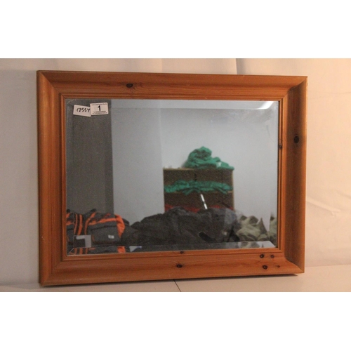 1 - A pine framed wall mirror with bevelled glass, measuring 46x60cm.