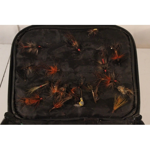 73 - A small waterproof case containing fishing flies, an LC fishing reels and more.