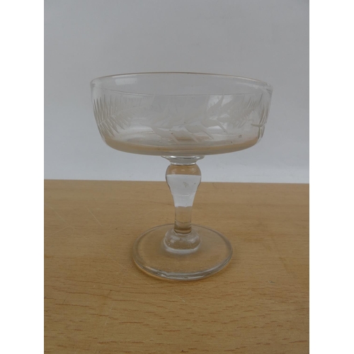 105 - An antique glass comport, etched with leaf decoration.