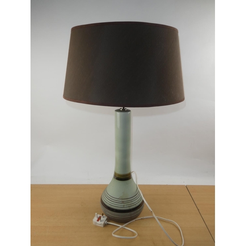 115 - A vintage ceramic based table lamp and shade.