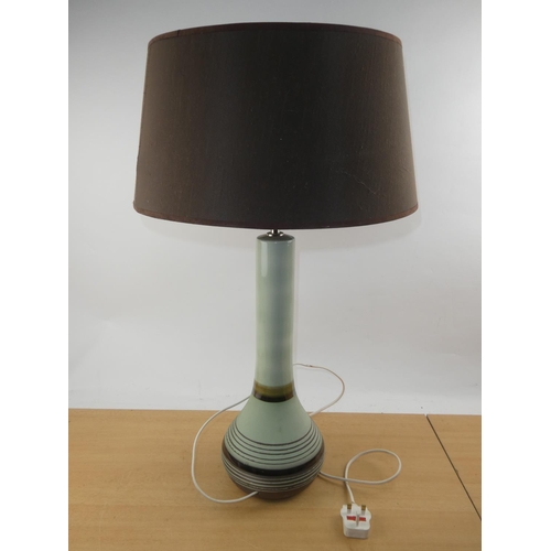 115 - A vintage ceramic based table lamp and shade.