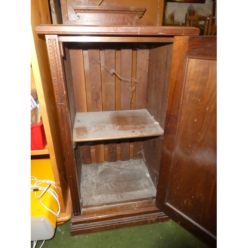 123 - An antique mahogany bedside cabinet with carved side panels.