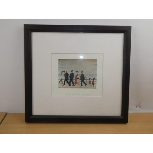 133 - A framed print 'On The Promenade' by L S Lowry.