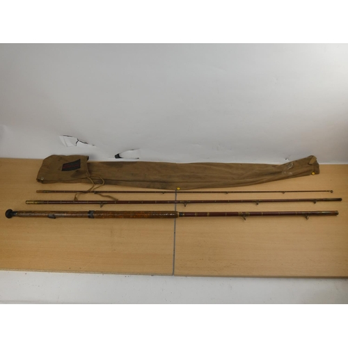 150 - A vintage three piece fishing rod and bag.