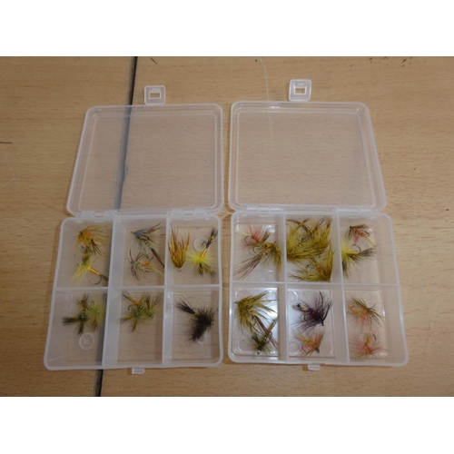175 - Two small plastic storage boxes containing fishing flies.
