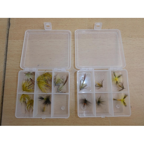 177 - Two small plastic storage boxes containing fishing flies.