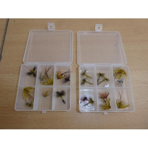 188 - Two small plastic storage boxes containing fishing flies.