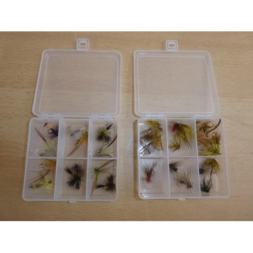 192 - Two small plastic storage boxes containing fishing flies.