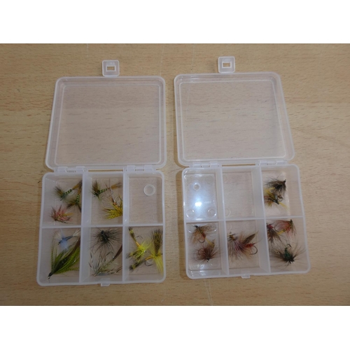 193 - Two small plastic storage boxes containing fishing flies.