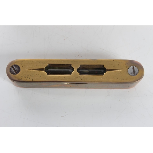 49 - A small antique bronze spirit level in fitted case.