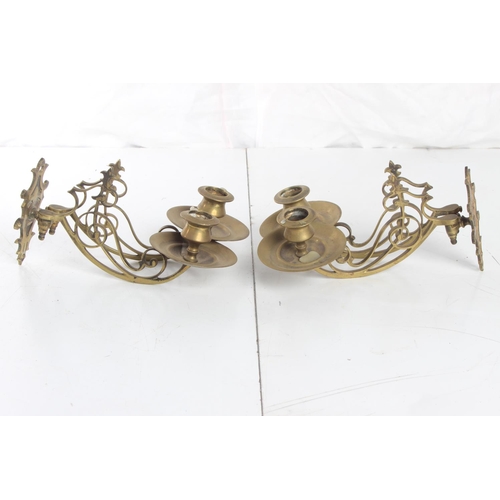 64 - A pair of decorative antique brass candle sconces.