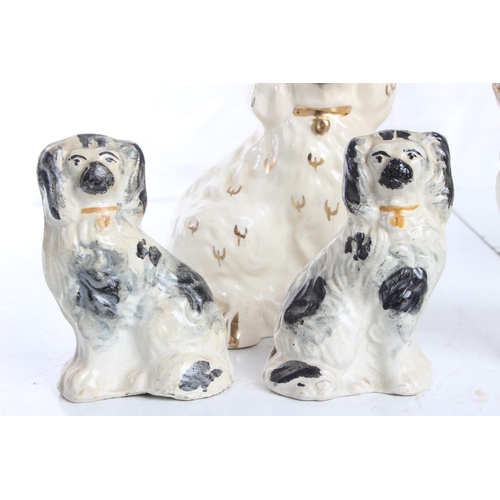 71 - A collection of antique Staffordshie Spaniels/ dogs, to include a pair by Beswick & more.